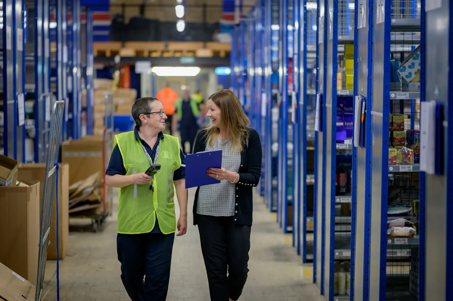 Two people reviewing inventory together in a warehouse