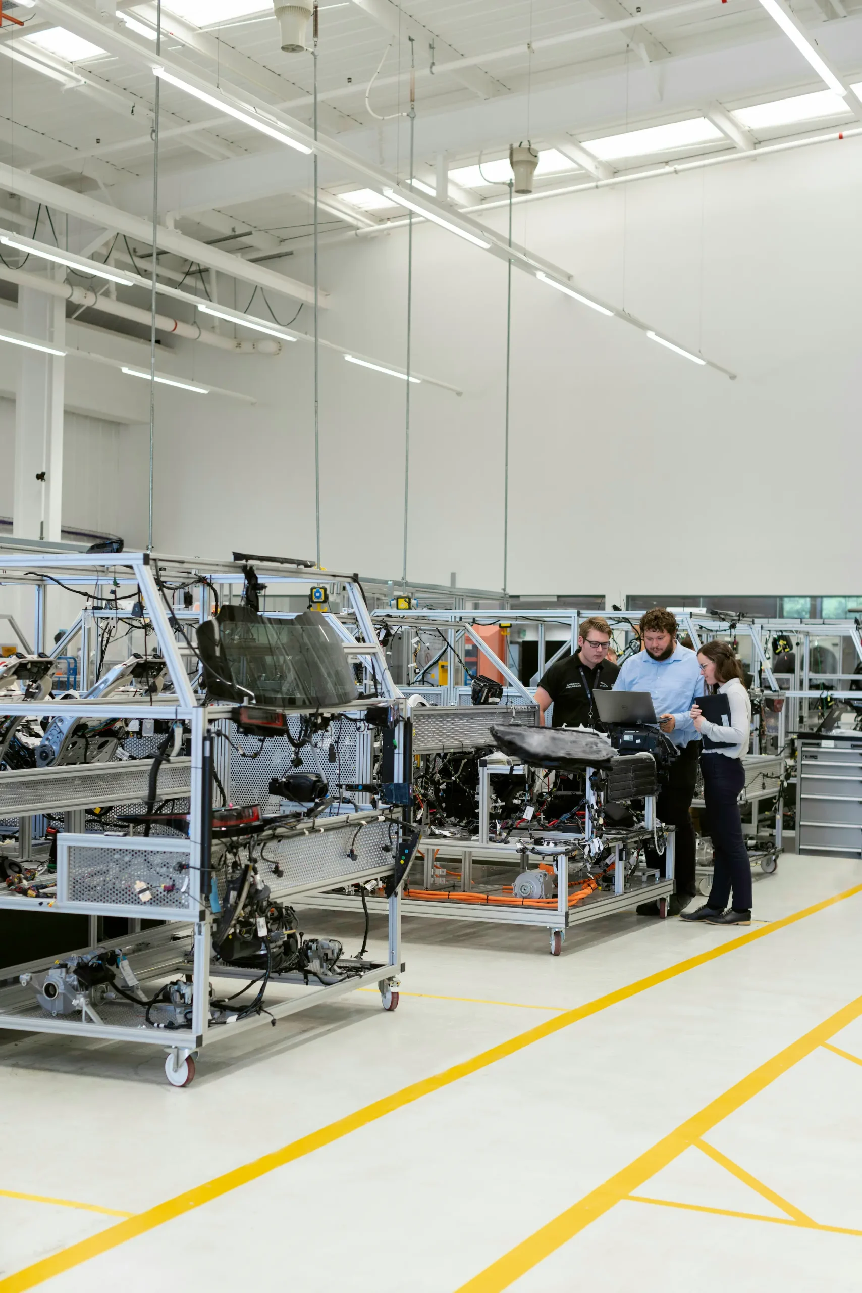 Engineers working hands-on together in an automotive factory